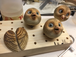 Bird puppet heads and wings are drying after the paint job and are ready for assembly