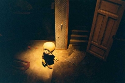 Stop-motion puppet sitting on the floor